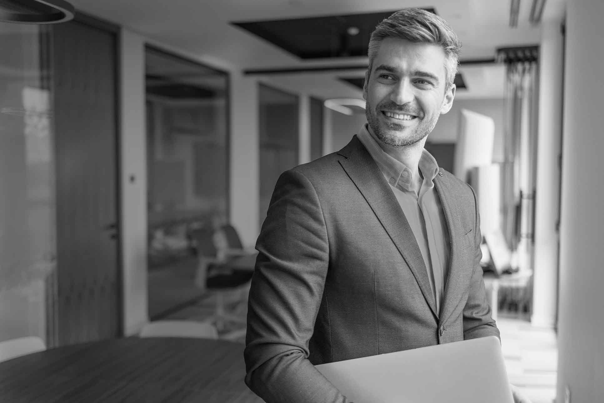 Smiling businessman with laptop